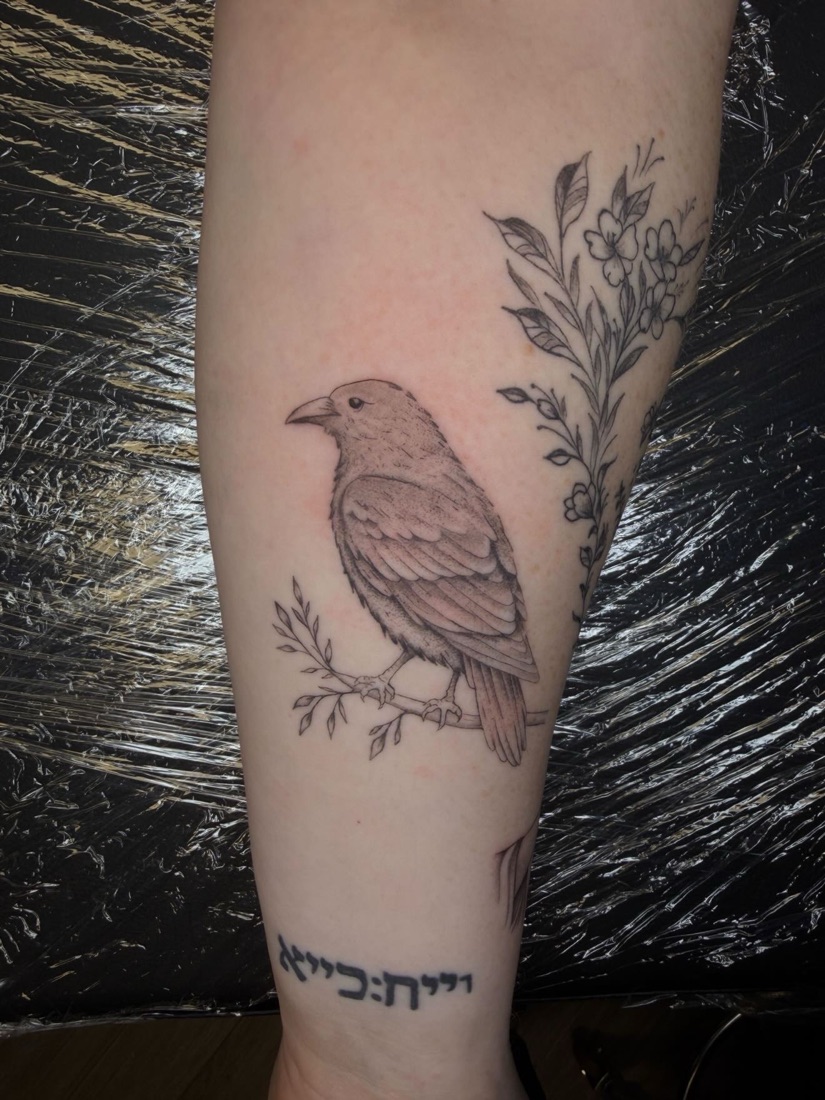 Fine-line bird tattoo