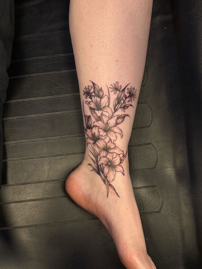 Trailing floral leg tattoo